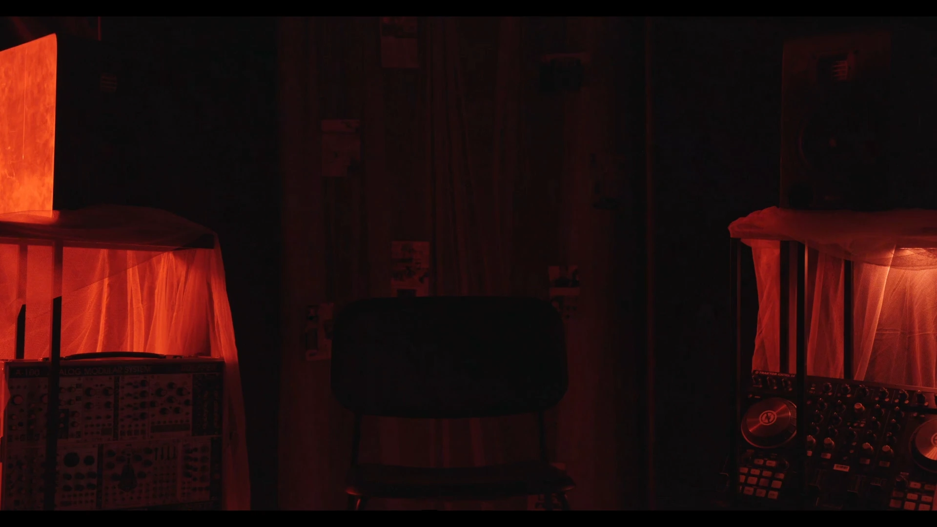 Dark stage with red wash, Behind the Concrete Wall
