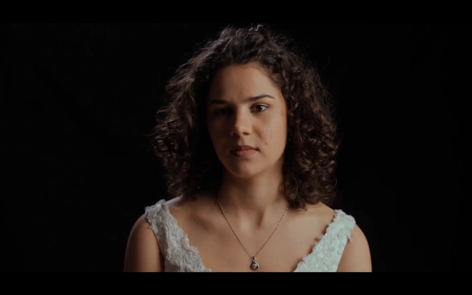 A bride in white by window light, still from Bride of Stolen