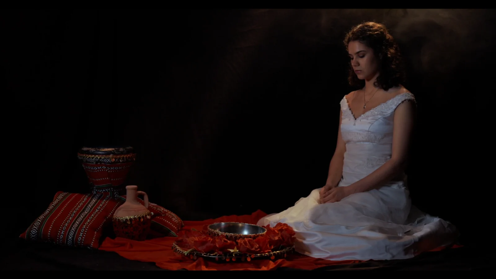 Bride seated among ceremonial objects in Bride of The Stolen Land